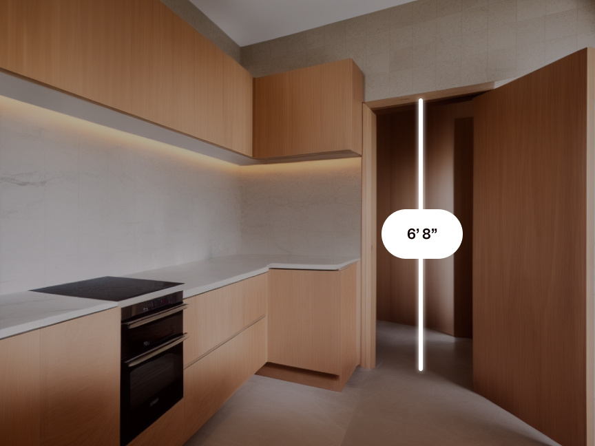 A modern kitchen with natural wood cabinetry. A digital measurement showing the height of the doorway is superimposed over it.