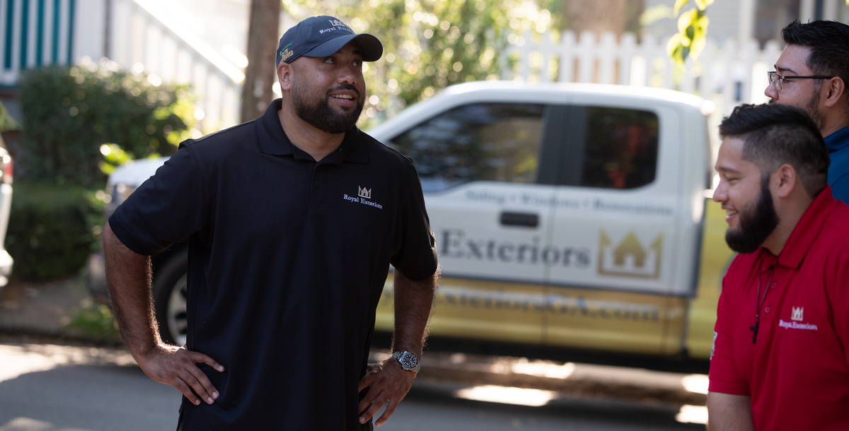 three hover contractors chatting near their truck - royal exteriors