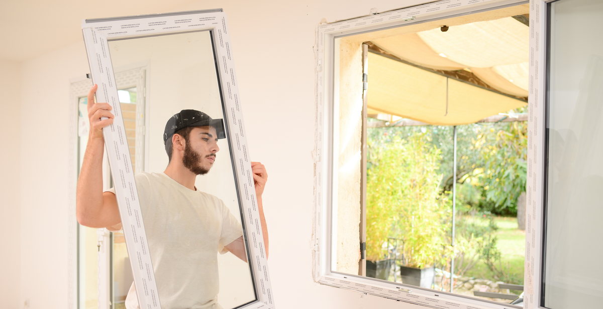 man installing new window